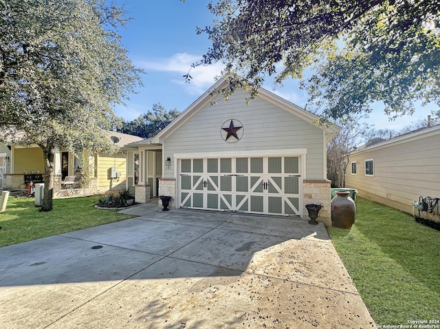 view of front of property with a front yard and a garage