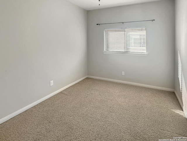 spare room featuring carpet