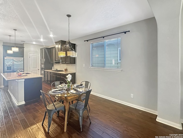 dining space with dark hardwood / wood-style floors and sink