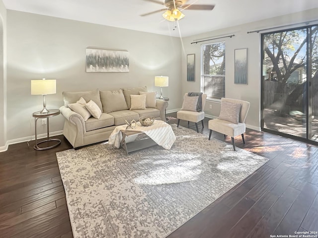 living room with ceiling fan and dark hardwood / wood-style flooring