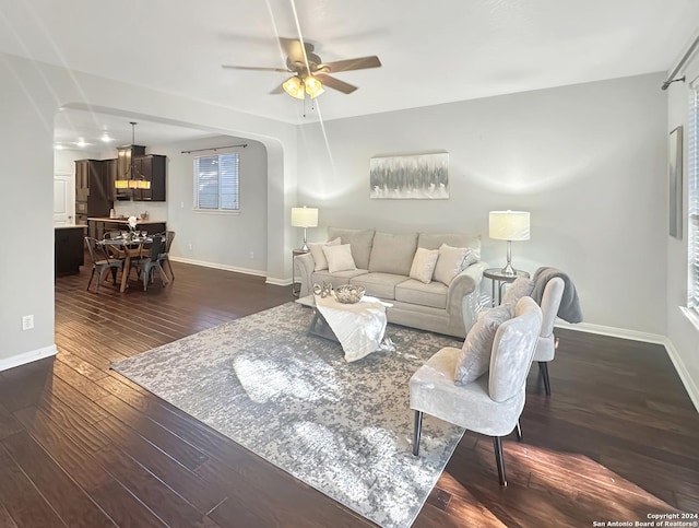 living room with dark hardwood / wood-style floors and ceiling fan