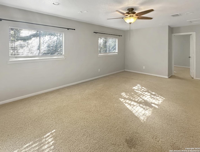 unfurnished room featuring ceiling fan and light colored carpet