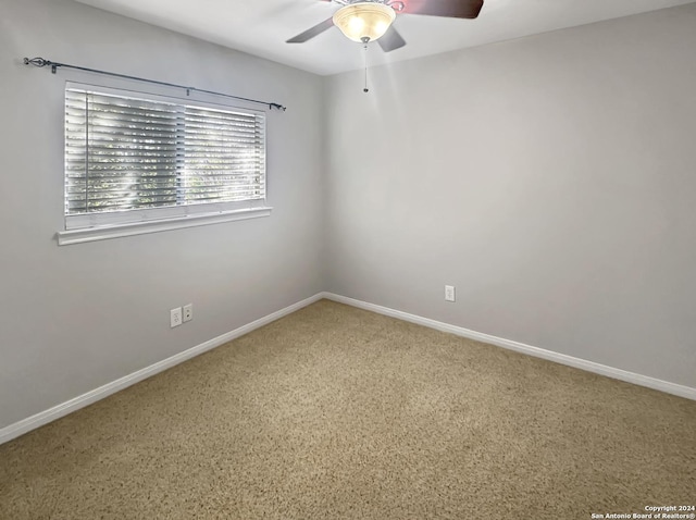 empty room featuring ceiling fan and carpet floors