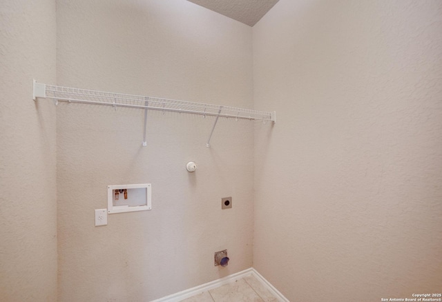 washroom with washer hookup, electric dryer hookup, gas dryer hookup, a textured ceiling, and light tile patterned flooring