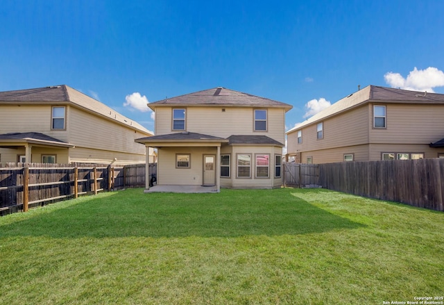 rear view of property with a yard and a patio