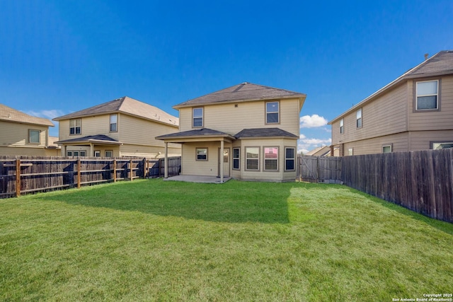 rear view of house with a lawn and a patio area