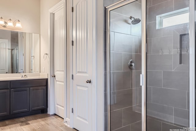 bathroom with vanity and a tile shower