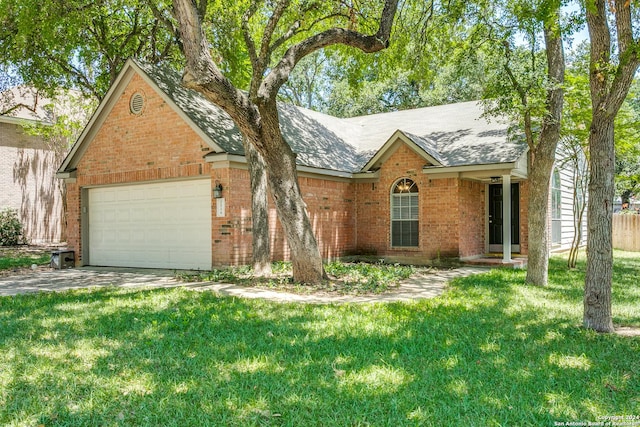 view of front of property featuring a garage and a front lawn