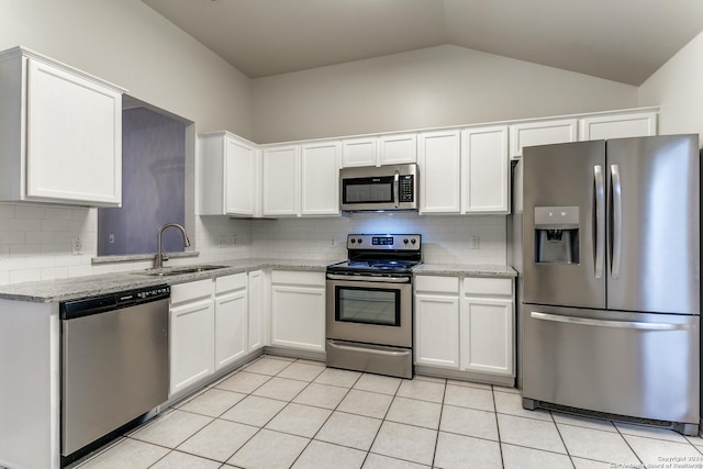 kitchen featuring light stone counters, sink, white cabinets, and stainless steel appliances