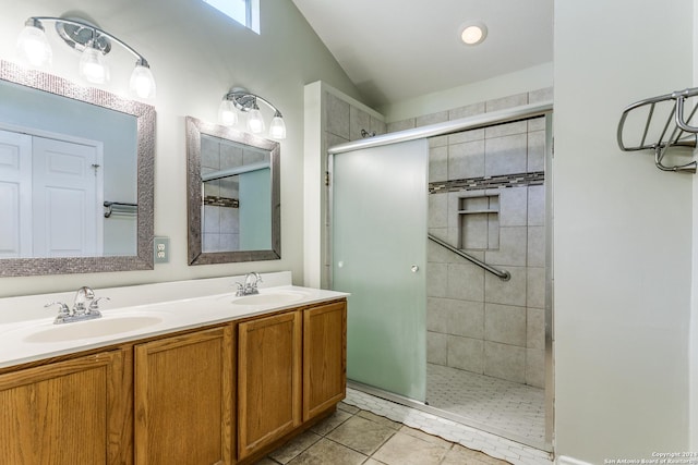 bathroom with tile patterned floors, vanity, vaulted ceiling, and a shower with shower door