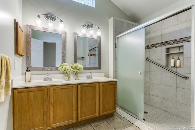 bathroom featuring tile patterned flooring, vanity, vaulted ceiling, and walk in shower