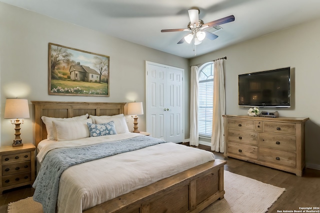 bedroom with ceiling fan, a closet, and dark hardwood / wood-style floors