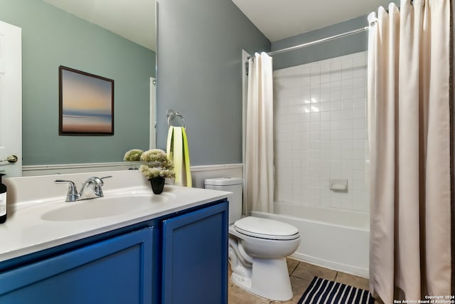 full bathroom featuring tile patterned flooring, vanity, shower / tub combo with curtain, and toilet