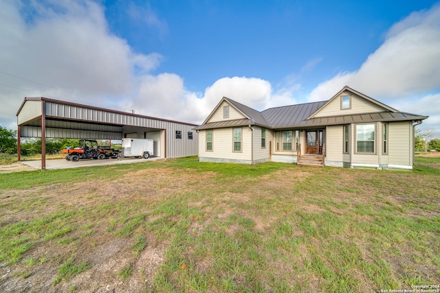 view of front of home with a carport, a garage, and a front lawn