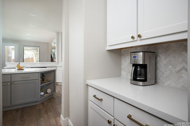 kitchen with gray cabinetry, dark hardwood / wood-style floors, white cabinets, and tasteful backsplash