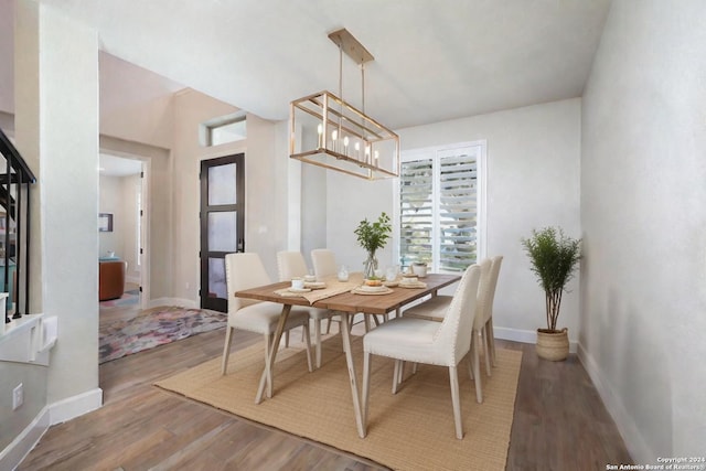 dining room featuring an inviting chandelier and hardwood / wood-style flooring