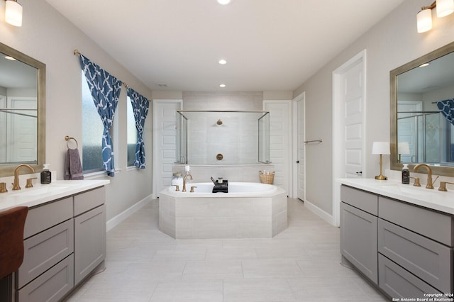 bathroom with vanity and separate shower and tub