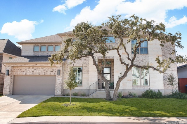 view of front of property with a front lawn and a garage