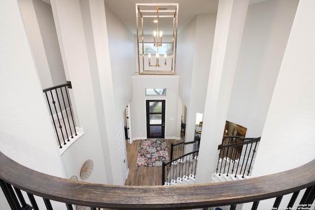 foyer entrance with a chandelier, a high ceiling, and hardwood / wood-style flooring