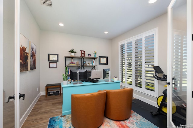 office with dark hardwood / wood-style flooring and french doors