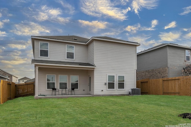 rear view of house featuring a yard and a patio