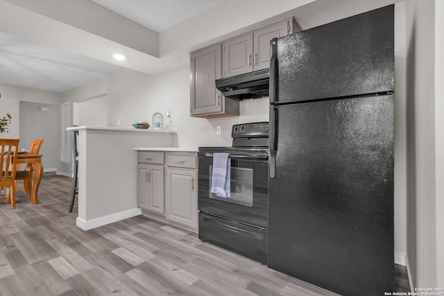 kitchen with gray cabinets, light hardwood / wood-style flooring, and black appliances