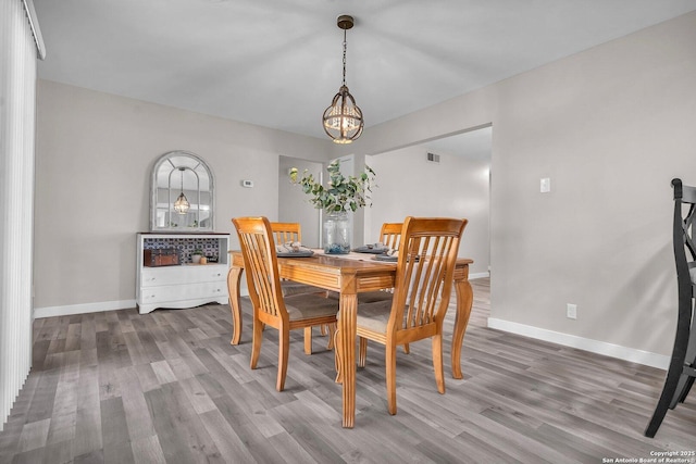 dining area with a chandelier and hardwood / wood-style flooring