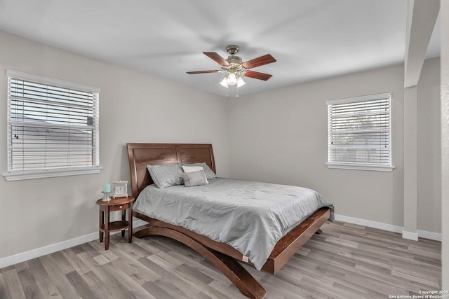 bedroom with ceiling fan and light wood-type flooring