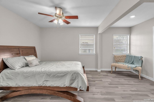 bedroom with ceiling fan and light wood-type flooring