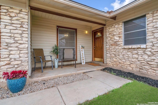 view of exterior entry with covered porch