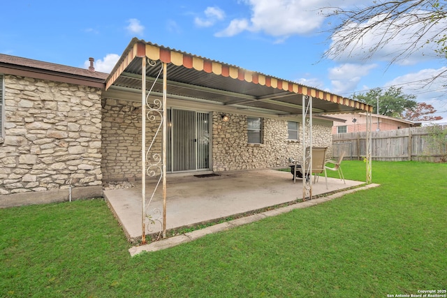 back of house featuring a patio area and a yard