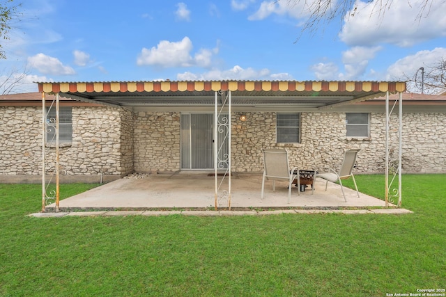 back of property featuring a yard and a patio area