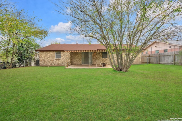 rear view of property featuring a patio area and a yard