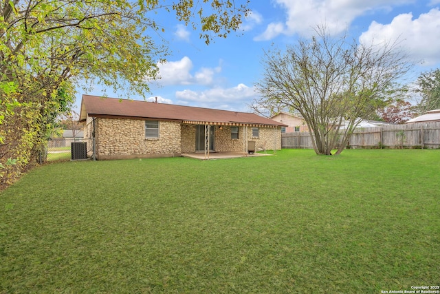 rear view of house with central AC, a yard, and a patio