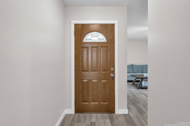 foyer entrance with light hardwood / wood-style floors