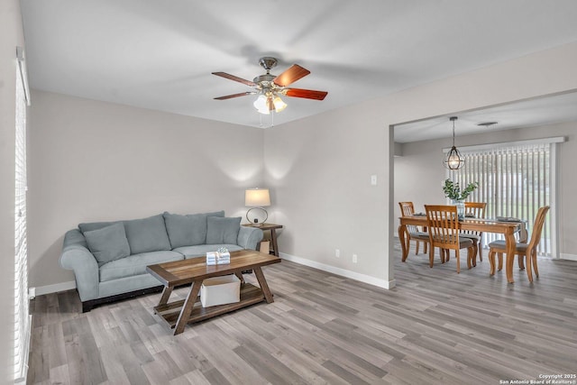 living room with hardwood / wood-style floors and ceiling fan