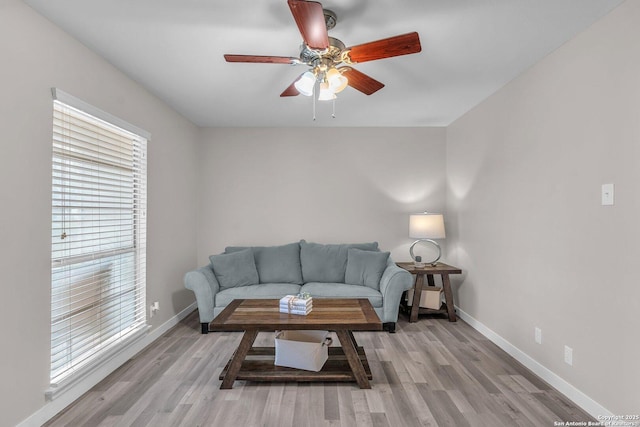 living room featuring ceiling fan and light wood-type flooring