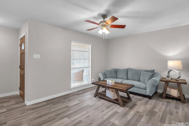 living room featuring hardwood / wood-style floors and ceiling fan