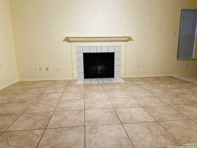 unfurnished living room with light tile patterned floors and a fireplace