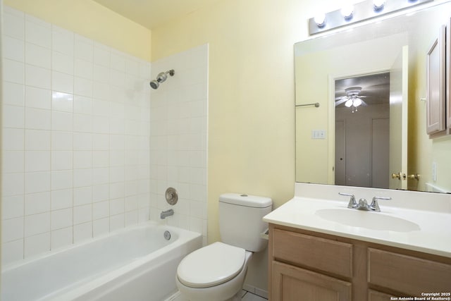 full bathroom featuring tiled shower / bath, ceiling fan, vanity, and toilet