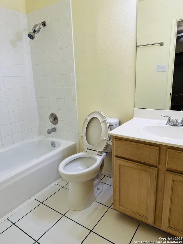 full bathroom with tile patterned floors, vanity, toilet, and tiled shower / bath