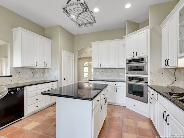 kitchen featuring black appliances, a center island, and white cabinets