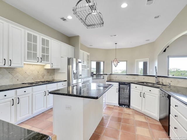 kitchen featuring white cabinetry, sink, a kitchen island, and stainless steel appliances