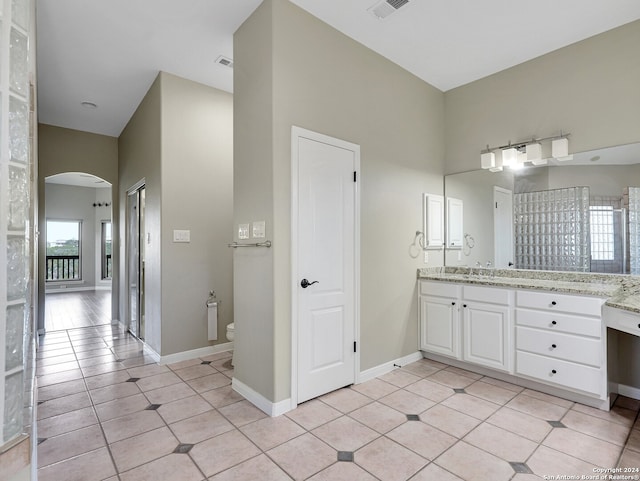 bathroom with tile patterned floors, vanity, and toilet