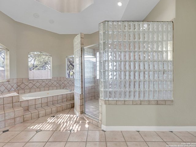 bathroom featuring tile patterned flooring and plus walk in shower