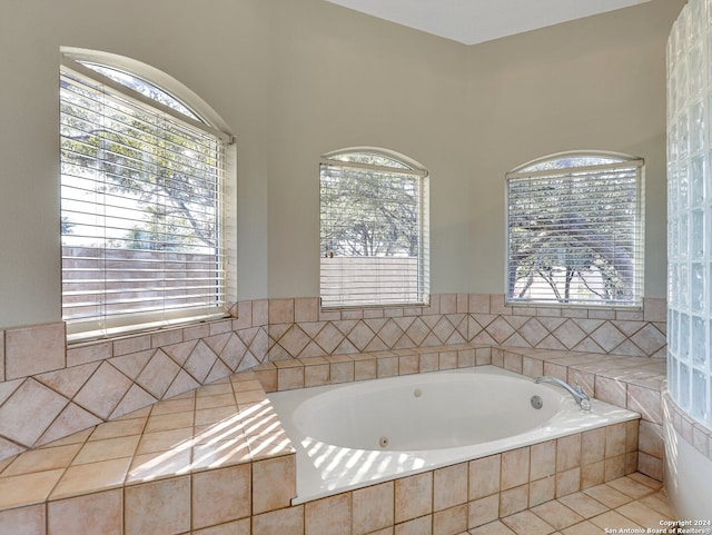 bathroom with a relaxing tiled tub