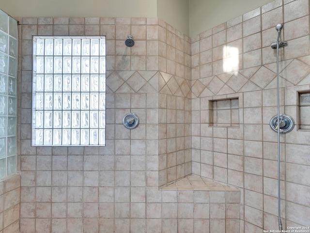 bathroom with tiled shower