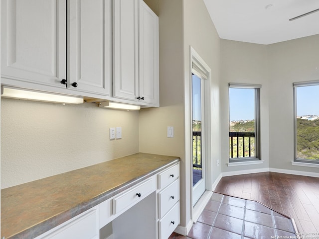 kitchen featuring wood-type flooring and white cabinetry