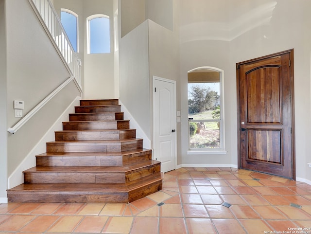 tiled entryway featuring a high ceiling