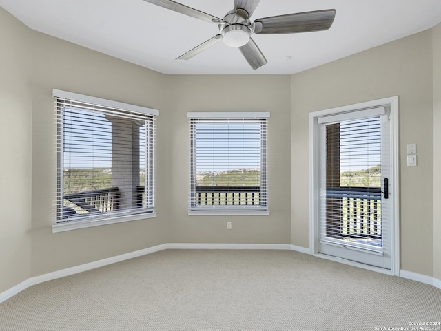 unfurnished room featuring carpet flooring, ceiling fan, and a healthy amount of sunlight